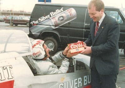 Claude H Wright receiving the first six pack of Coors flown into Rochester in 1987.